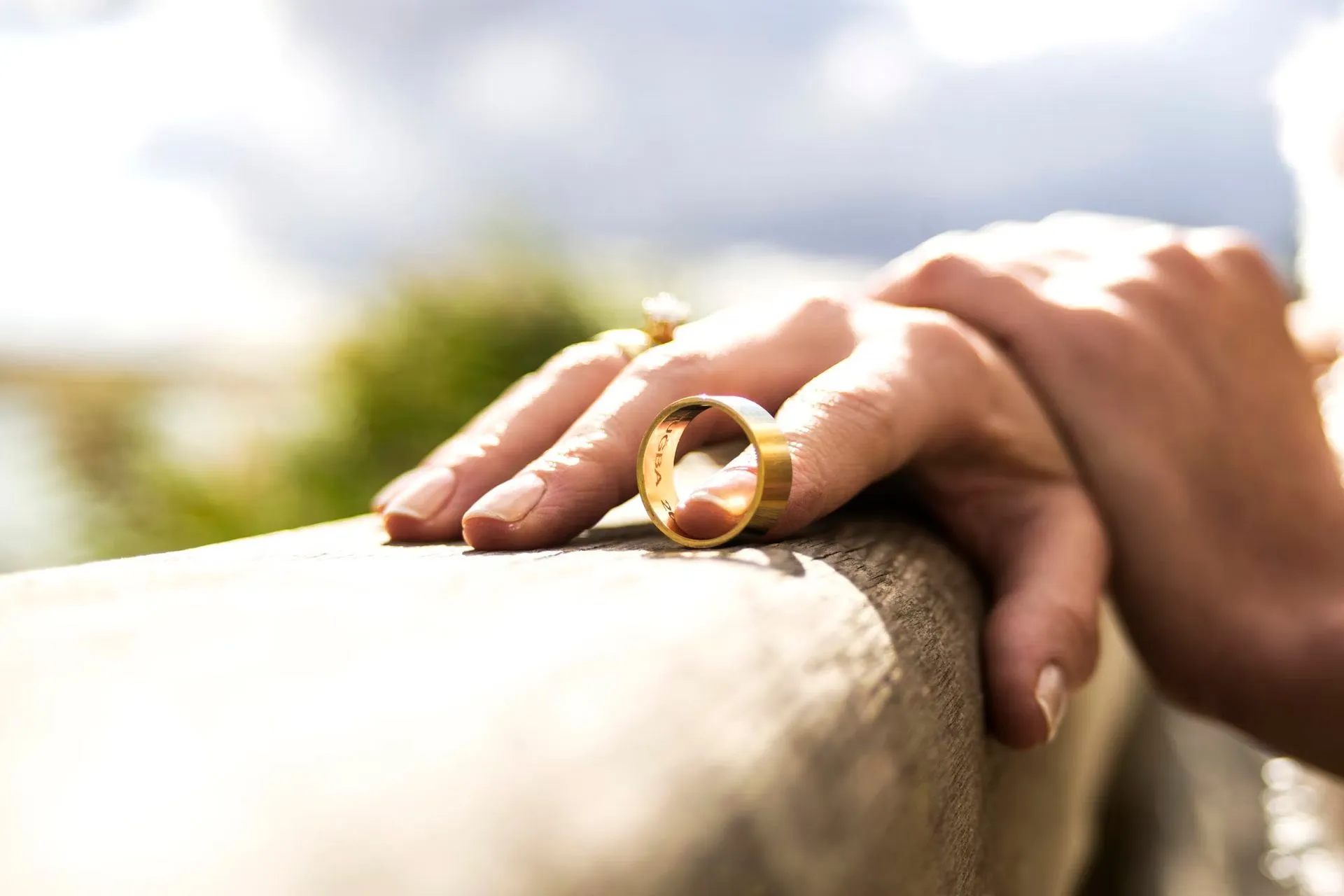 hand-holding-a-wedding-band-with-finger