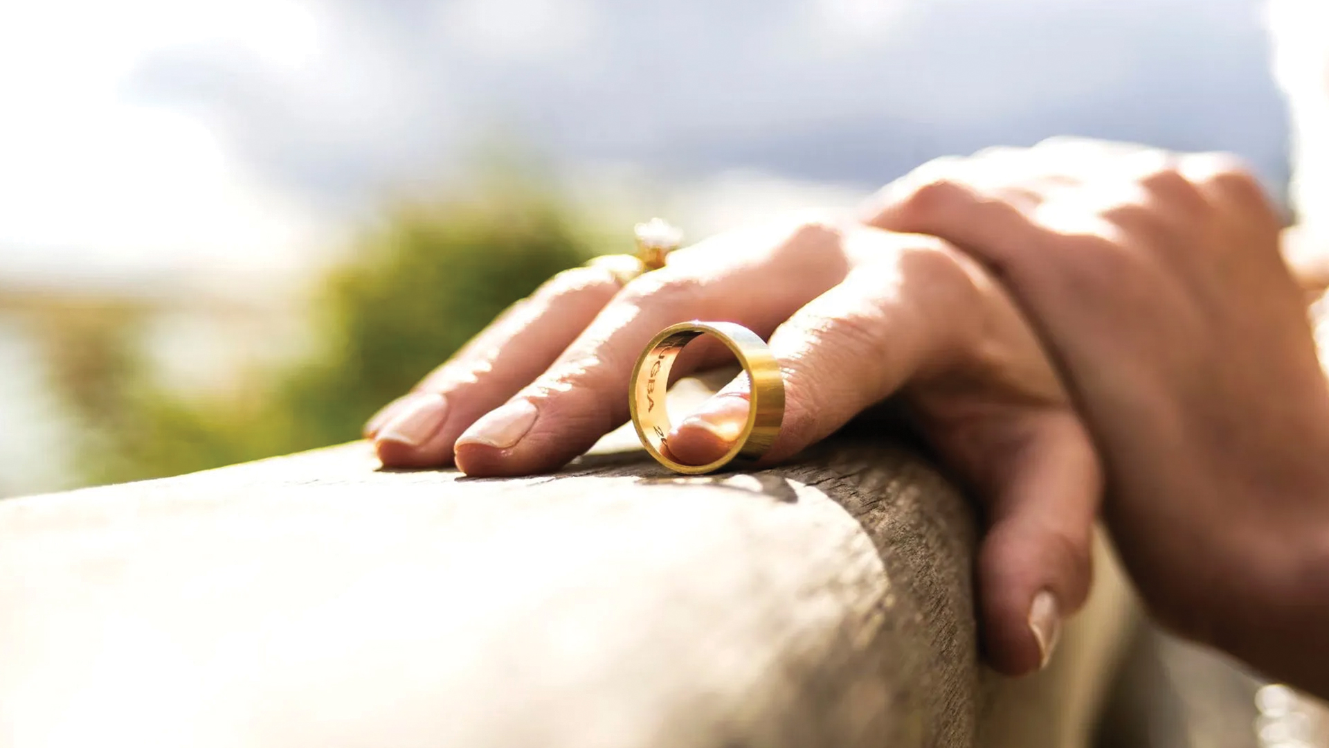 hand-holding-a-wedding-band-with-finger